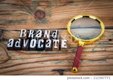 BRAND ADVOCATE. Alphabet letters on wood texture background BRAND ADVOCATE. Alphabet letters on wood texture background 112307771