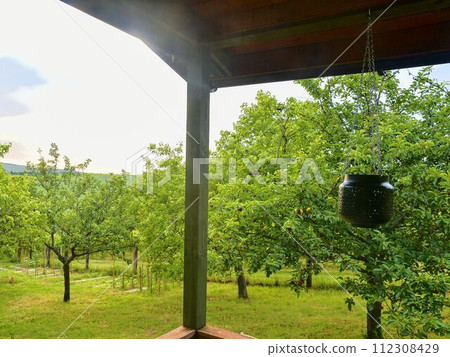 Wooden garden shed in a beautiful rural orchard. Close-up Wooden garden shed in a beautiful rural orchard. Close-up 112308429