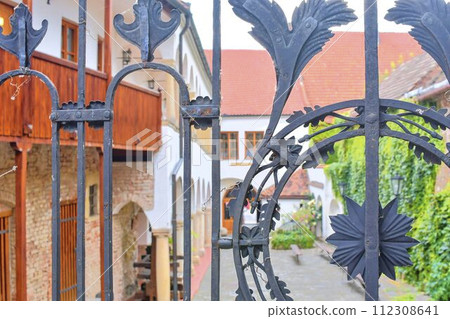 View on romantic urban scenery through forged banister. Historic urban backyard 112308641