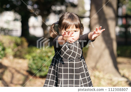 little girl playing in the winter park 112308807