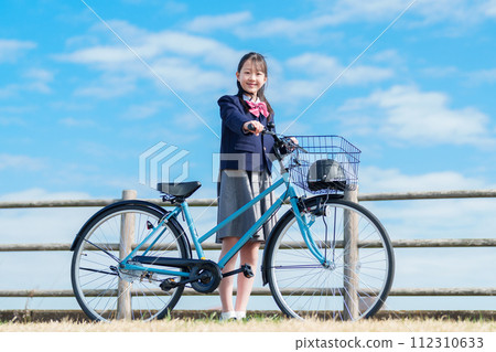Girls going to school by bicycle Girls going to school by bicycle 112310633