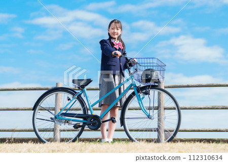 Girls going to school by bicycle 112310634