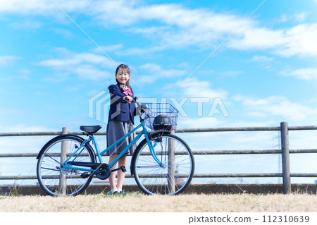 Girls going to school by bicycle Girls going to school by bicycle 112310639