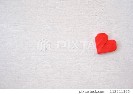 Plaster wall and origami heart 112311365