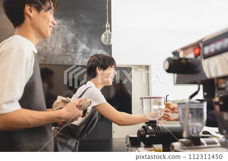 Cafe clerk serving coffee Cafe clerk serving coffee 112311450
