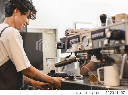 Male cafe clerk brewing coffee Male cafe clerk brewing coffee 112311467