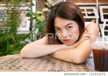 Lonely bored Asian woman waiting for her friend alone in the coffee shop. 112312272