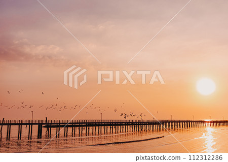 Sunset sea view seascape orange sky with long bridge. 112312286