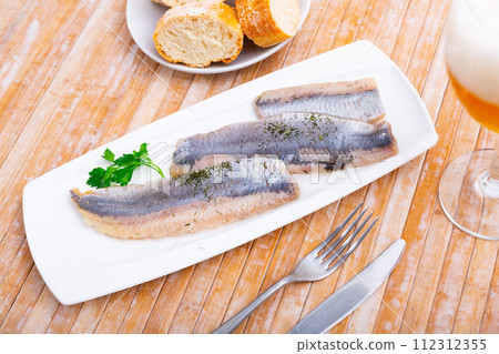 Close up slices of slightly salted herring with parsley 112312355