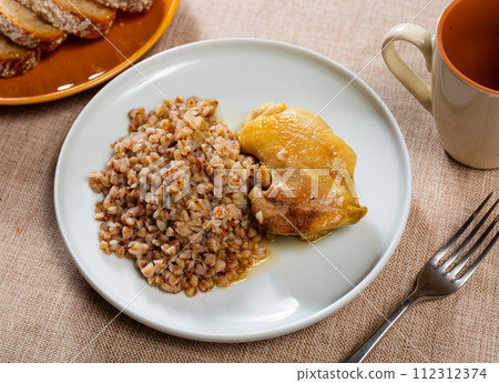 Chicken thighs with buckwheat, delicious dinner Chicken thighs with buckwheat, delicious dinner 112312374
