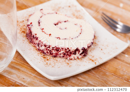 Slice of tasty cheese roll filled with cranberries closeup Slice of tasty cheese roll filled with cranberries closeup 112312470