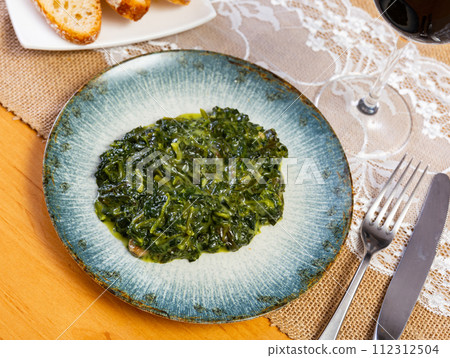 Traditional regional Spanish dish is spinach in Catalan Traditional regional Spanish dish is spinach in Catalan 112312504