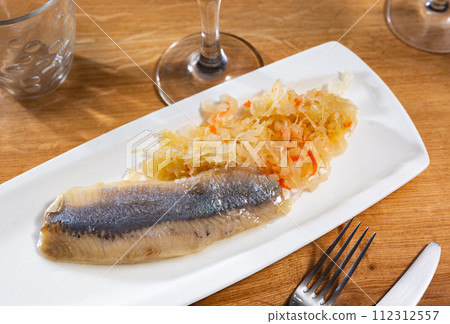 Sliced herring served with sauerkraut Sliced herring served with sauerkraut 112312557