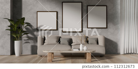 A contemporary living room features a grey couch, a coffee table, and frames mockup on a loft wall. A contemporary living room features a grey couch, a coffee table, and frames mockup on a loft wall. 112312673