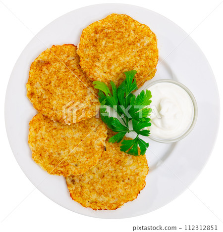 Potato pancakes served with sour cream 112312851