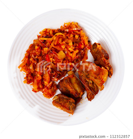 Delicious pork ribs in gravy with barley and cabbage stewed close up 112312857