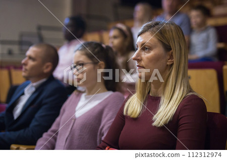 portrait of female caucasian viewer sitting at premiere in theatrical hall portrait of female caucasian viewer sitting at premiere in theatrical hall 112312974
