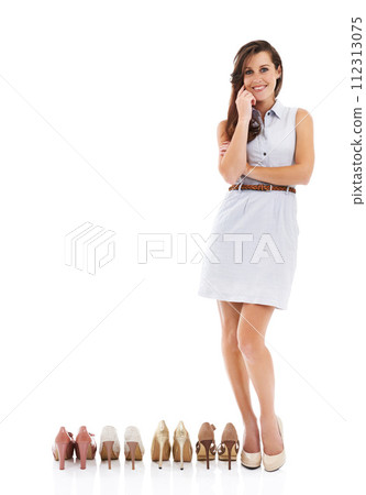 Woman, many shoes and studio portrait with choice, mockup space and feet for fashion by white background. Person, model and high heels for trendy style, happy and pride for promotion with retail deal 112313075