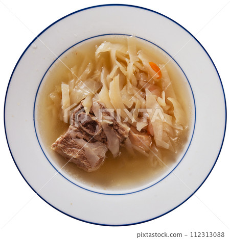 Fragrant cabbage soup with pork rib. Dish is complemented with plate of bacon and bread. 112313088