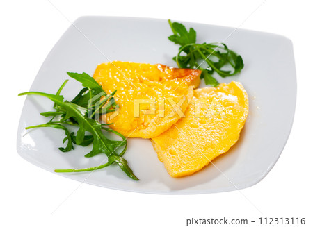 Two pieces of fried omelet decorated with arugula leaves are served for breakfast in restaurant 112313116