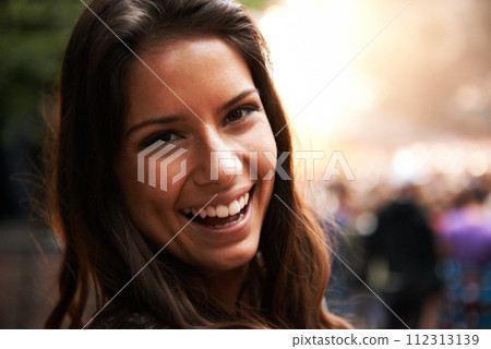 Portrait, smile and a young woman at a music festival for energy, freedom or celebration outdoor. Face, party and excitement with a happy person in the crowd or audience of a concert performance 112313139
