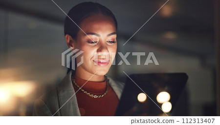 Business woman, smile and tablet at night in office to search online report, scroll information and website planning. Happy corporate employee working late on digital data, tech or social network app 112313407