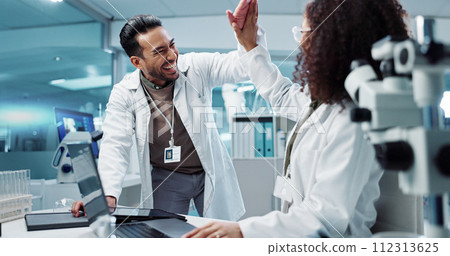 Scientist, teamwork and high five with laptop in laboratory for test breakthrough, pharmaceutical review or success. Science, collaboration or technology for research, discussion and digital analysis 112313625