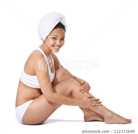 Woman, legs and skin care in studio portrait for hair removal results and beauty on floor on a white background. Young person or happy model in underwear with body cosmetics, skincare and dermatology 112313640