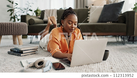 Laptop, education and a student black woman on the floor of a living room to study for a test or exam. Computer, smile and a happy young person learning with an online course for upskill development Laptop, education and a student black woman on the floor of a living room to study for a test or exam. Computer, smile and a happy young person learning with an online course for upskill development 112313952