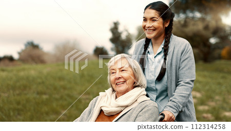 Happy, senior woman and outdoor with caregiver, nurse or healthcare service for person with a disability and wheelchair. Face, smile and elderly lady in park with care or support in retirement 112314258