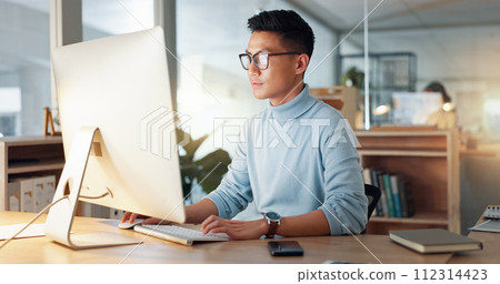 Asian man at computer, glasses and ideas, thinking and reading email, web review or article at digital agency. Research, reflection and businessman at tech startup networking on business website. 112314423