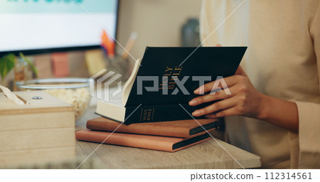 Bible, religion and hands of person reading holy Christian book to worship God for spiritual learning and trust. Faith, knowledge and person with peace due to scripture, praise and gratitude in home 112314561