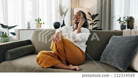 Funny, phone call and black woman in home, talking or communication on sofa. Smartphone, conversation and African person laughing, listening to story and comedy, chat or news and happy in living room Funny, phone call and black woman in home, talking or communication on sofa. Smartphone, conversation and African person laughing, listening to story and comedy, chat or news and happy in living room 112314589