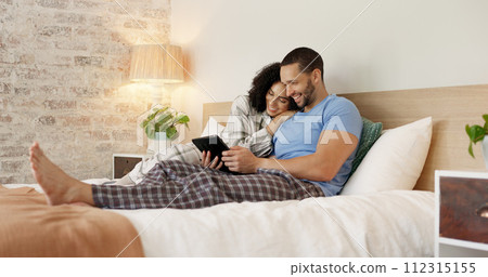 Couple, tablet and relax in home bedroom, laugh or morning with video, movie or meme for love, care or hug. Man, woman and digital touchscreen for typing, social network app or bond together in house 112315155