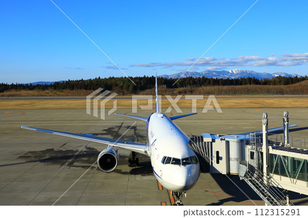 Akita Airport Passenger plane and Ou Mountains 112315291