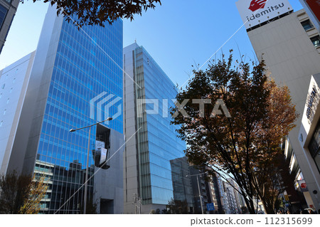 A cityscape with tall buildings, trees, and green foliage Nov 28 2023 112315699