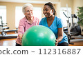 A physical therapist works with a senior woman during a therapy 112316887