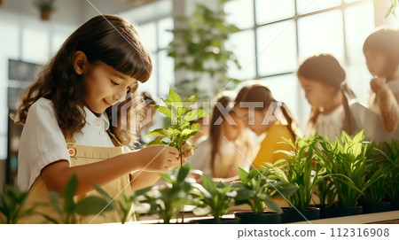 Image description: A young girl is carefully examining a small Image description: A young girl is carefully examining a small 112316908