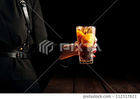 Woman holding glass of long island ice tea 112317621