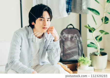 Young man relaxing in the living room Young man relaxing in the living room 112320283
