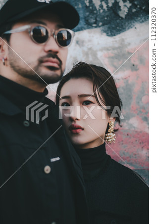 Young couple standing in front of street art 112320370