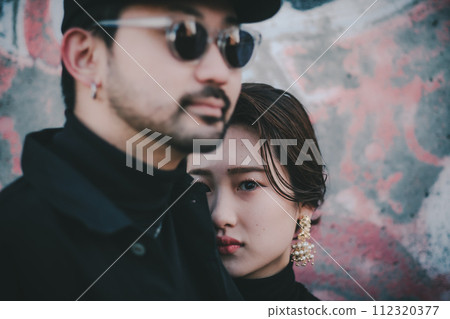 Young couple standing in front of street art Young couple standing in front of street art 112320377