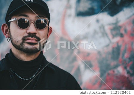 man standing in front of street art 112320401