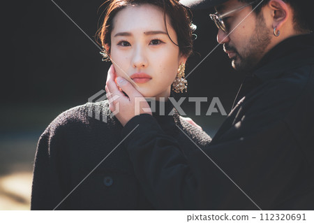 man putting hand on woman's face 112320691