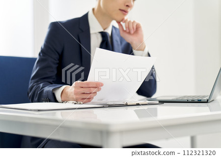 Businessman checking the contents of documents 112321320