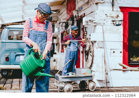 Photo of a senior couple doing gardening work together Photo of a senior couple doing gardening work together 112322064
