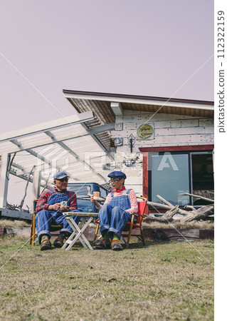 Photo of a senior couple relaxing in the garden Photo of a senior couple relaxing in the garden 112322159