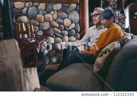 A picture of a senior couple sitting on a sofa in harmony 112322193