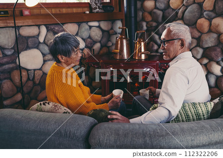 A picture of a senior couple sitting on a sofa in harmony 112322206