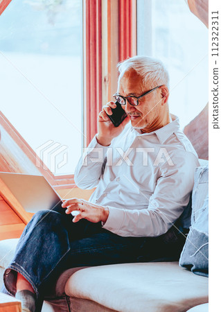 Photo of a senior man working from home Photo of a senior man working from home 112322311